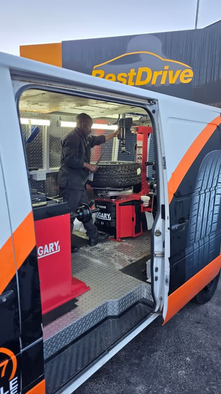 Best Drive technician fitting a tyre inside the mobile van