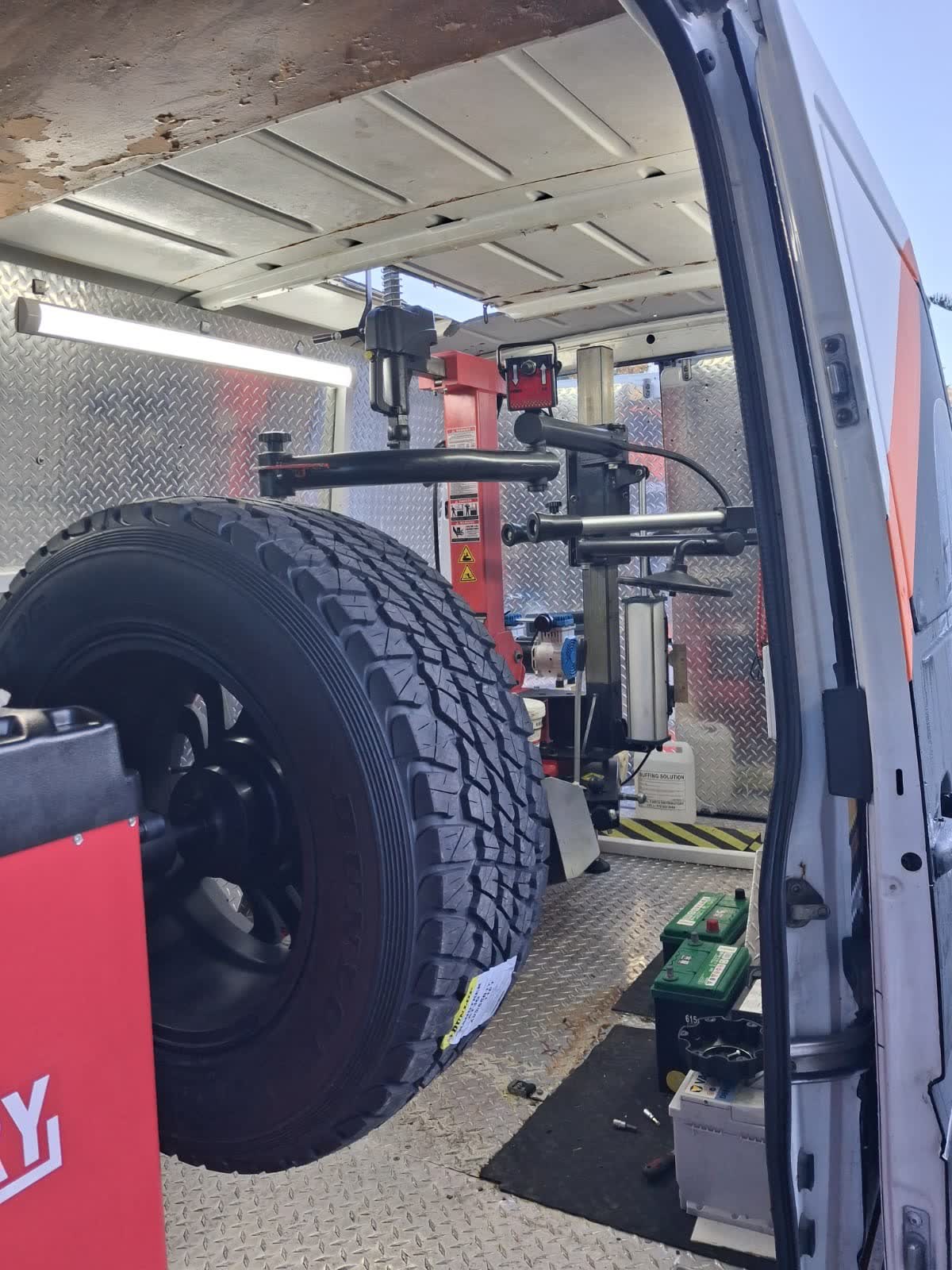 Car batteries and tyre fitting equipment loaded inside the Best Drive mobile van